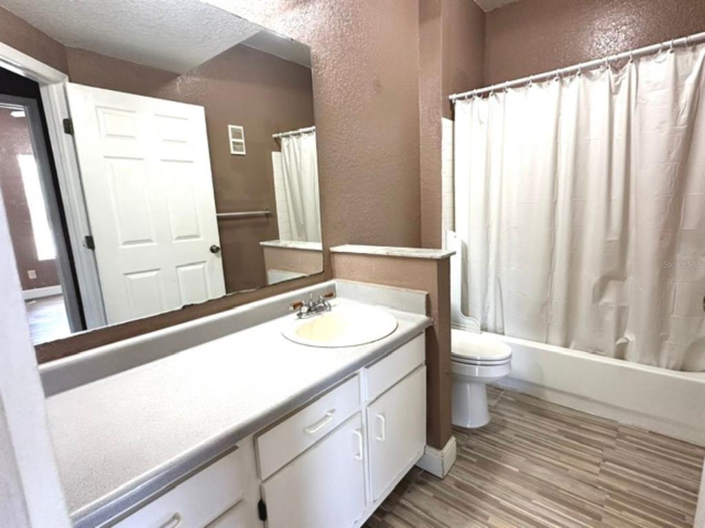 822 Camargo Way, Unit 204 Altamonte Springs, FL 32714 - Photo 20 of 32 a bathroom with a sink a toilet and a large mirror