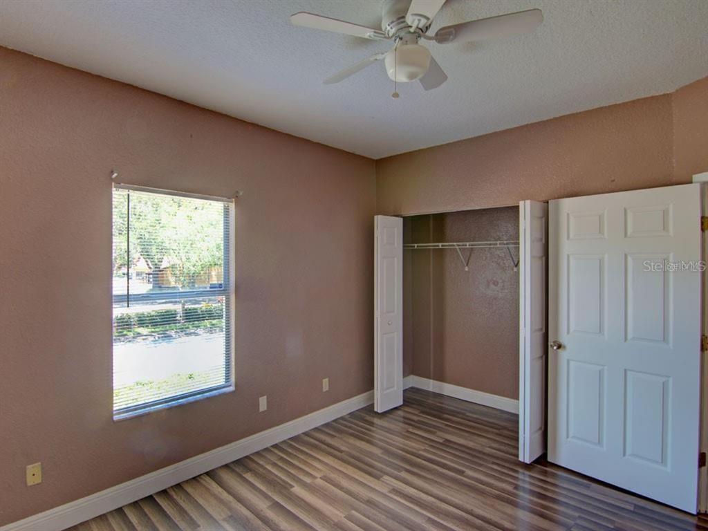 822 Camargo Way, Unit 204 Altamonte Springs, FL 32714 - Photo 21 of 32 a view of an empty room with wooden floor and a window