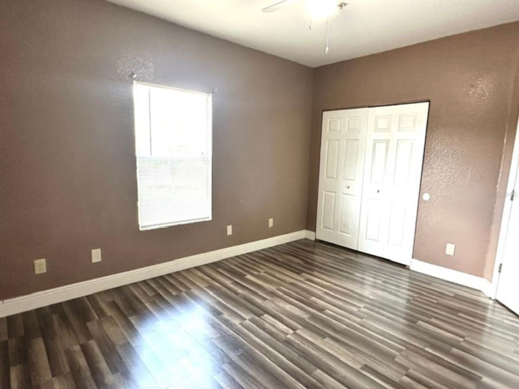 822 Camargo Way, Unit 204 Altamonte Springs, FL 32714 - Photo 22 of 32 an empty room with wooden floor and windows