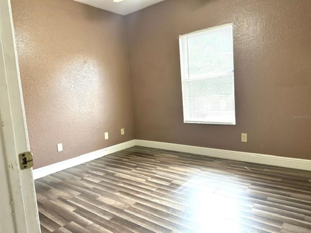822 Camargo Way, Unit 204 Altamonte Springs, FL 32714 - Photo 23 of 32 a view of an empty room with wooden floor and a window