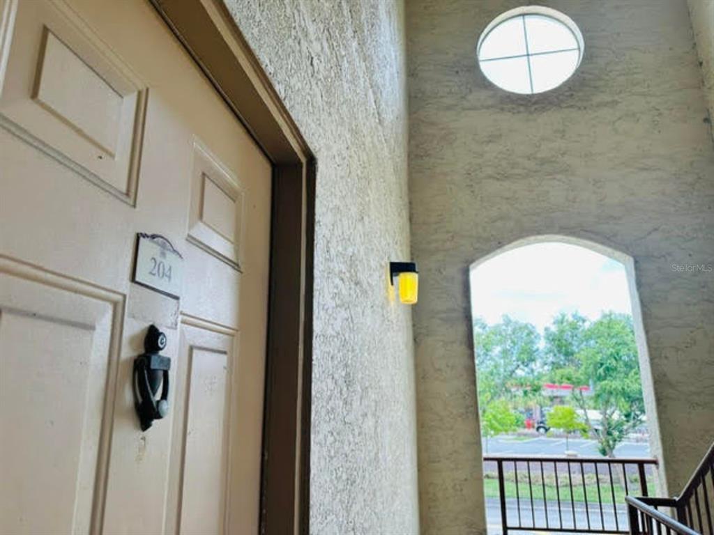 822 Camargo Way, Unit 204 Altamonte Springs, FL 32714 - Photo 6 of 32 a view of a hallway with wooden floor and glass windows