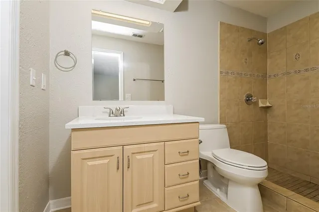 an empty room with a window and a ceiling fan