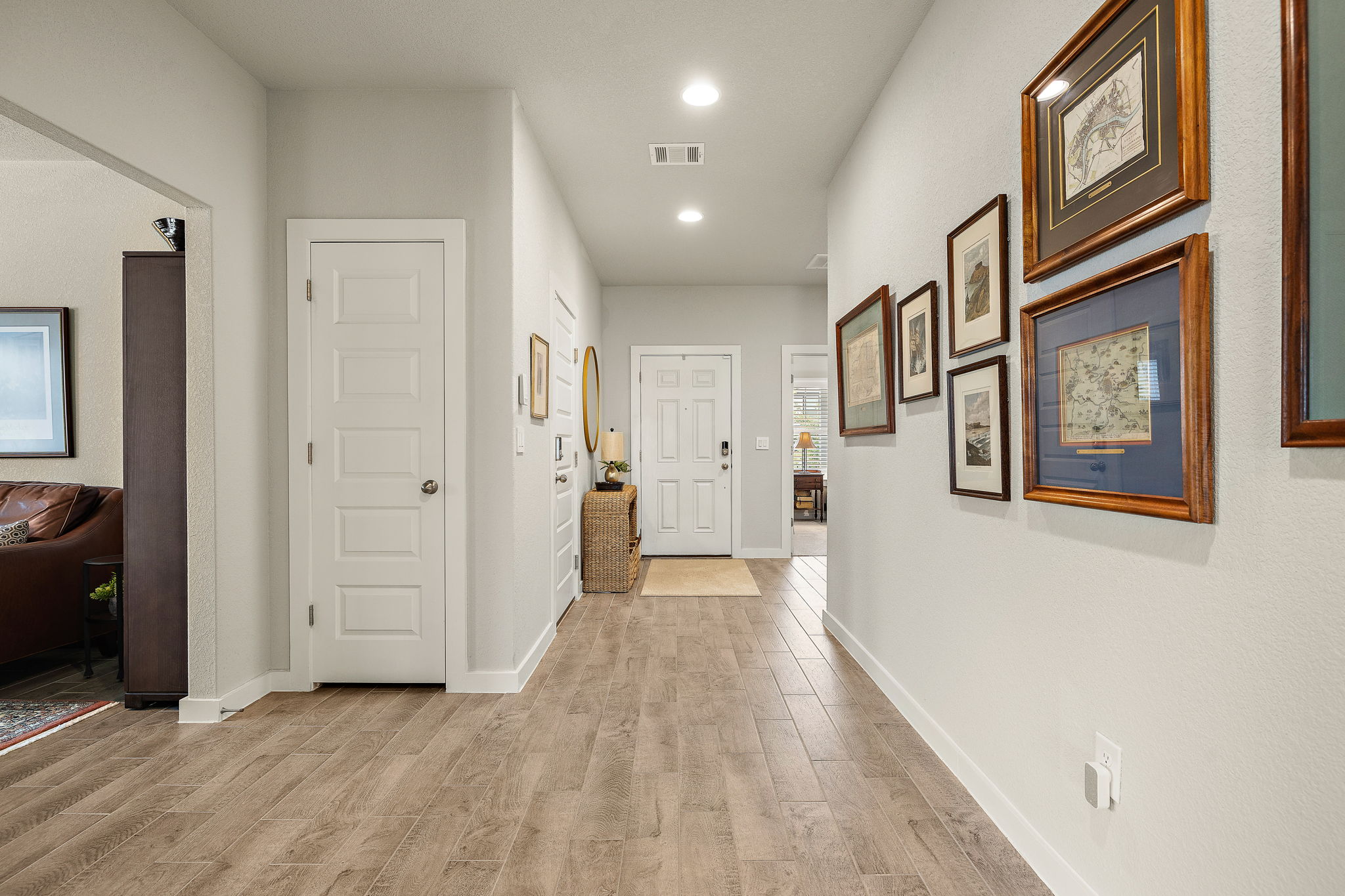 234 Appleberry Lane Elgin, TX 78621 - Photo 7 of 28 Wood-look tile flooring flows through the main living areas, creating a clean, cohesive look while keeping upkeep simple.