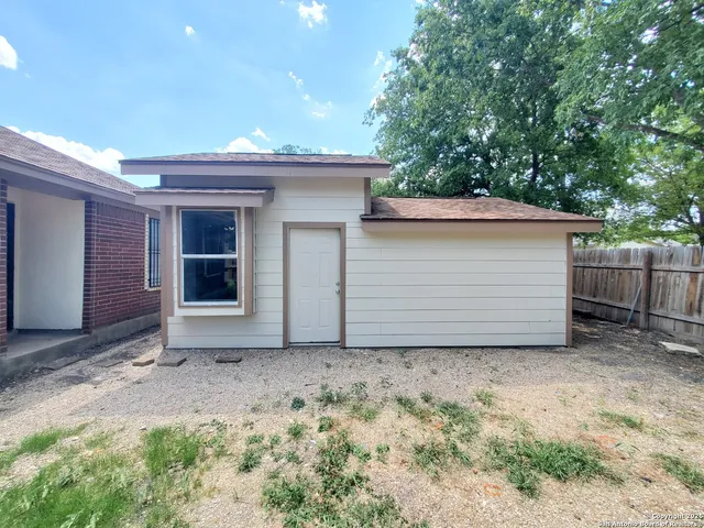 a view of backyard with cabin