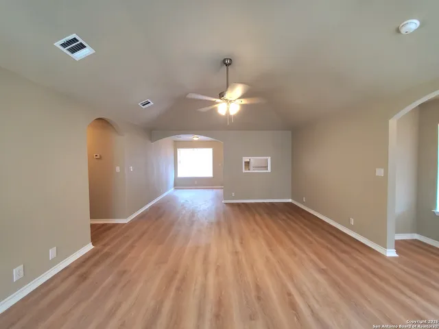 wooden floor in an empty room with a window