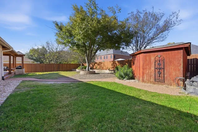 a view of backyard with swimming pool and green space