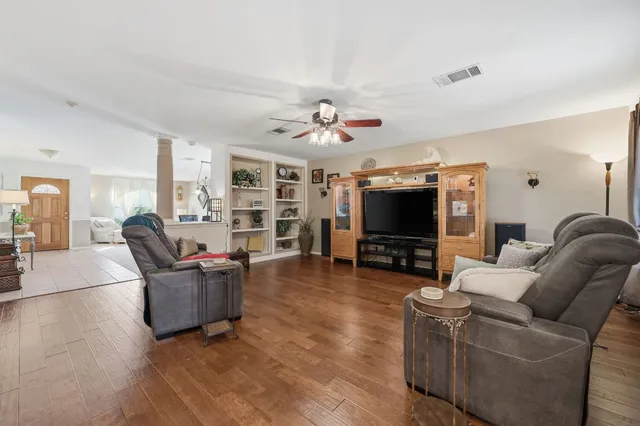 a living room with furniture and a flat screen tv