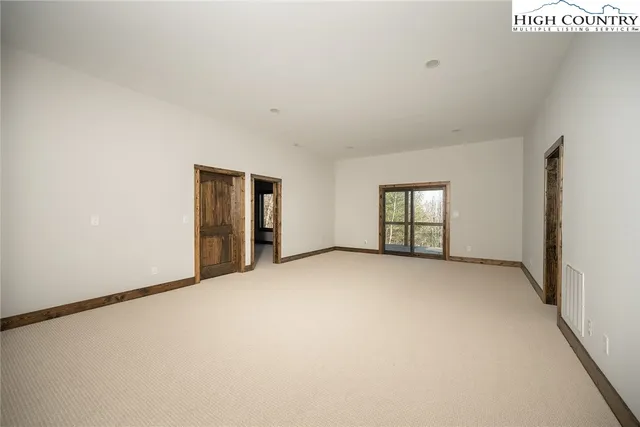 a view of a dry yard with trees