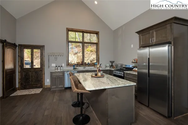 a kitchen with refrigerator and window