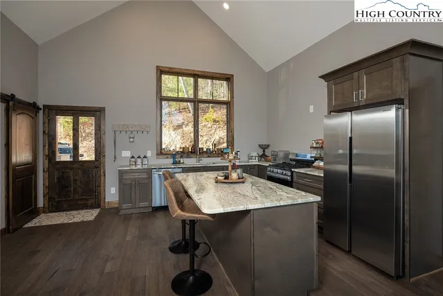 a kitchen with refrigerator and window