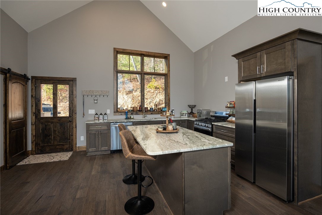 414 Elk Horn Road Ferguson, NC 28624 - Photo 3 of 27 a kitchen with refrigerator and window