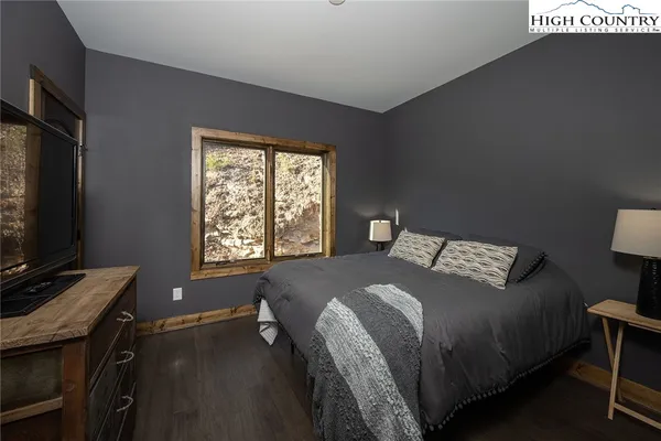 a bed sitting in a bedroom next to a window