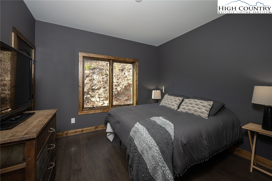 414 Elk Horn Road Ferguson, NC 28624 - Photo 6 of 27 a bed sitting in a bedroom next to a window