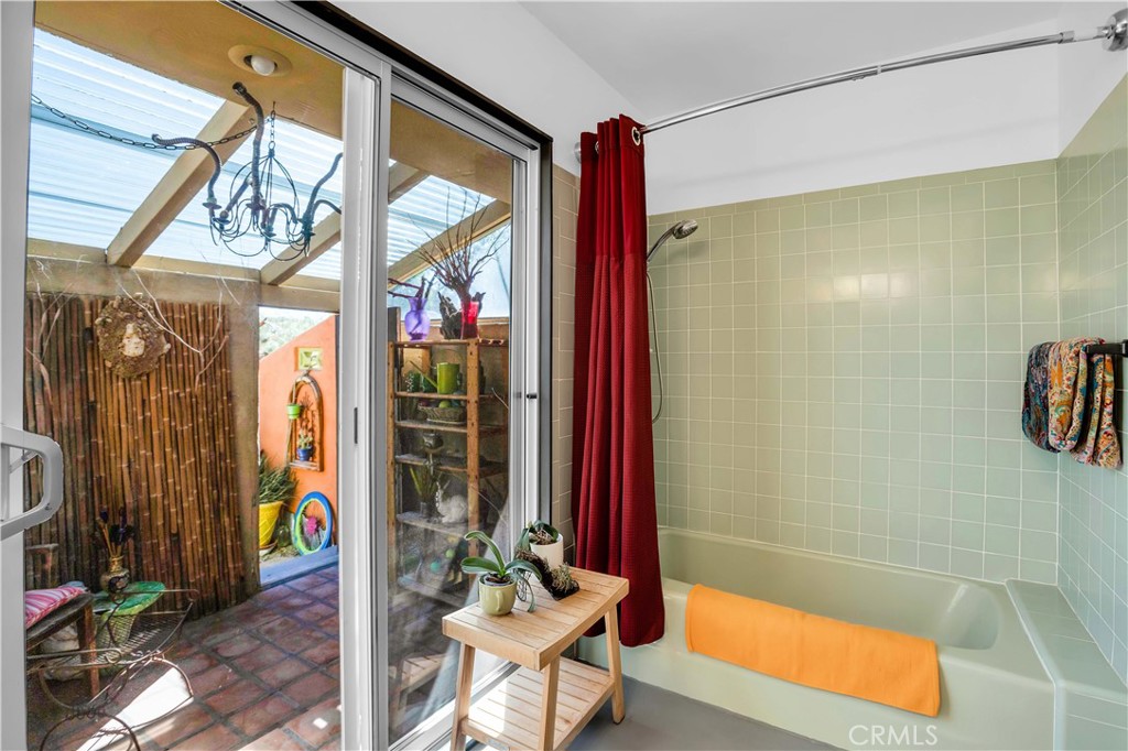 59489 Onaga Trail Joshua Tree, CA 92252 - Photo 24 of 73 a bathroom with a bathtub and a shower