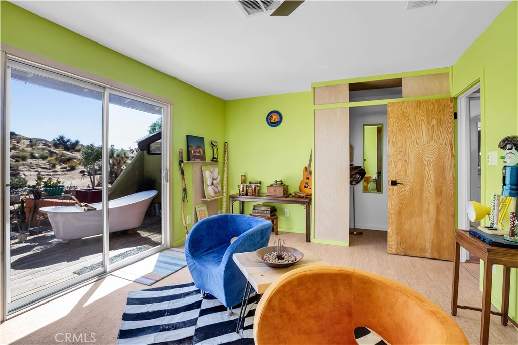 59489 Onaga Trail Joshua Tree, CA 92252 - Photo 27 of 73 a living room with furniture and a large window