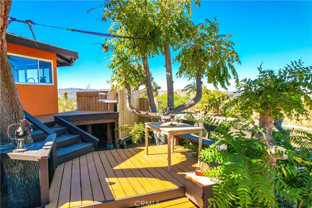 59489 Onaga Trail Joshua Tree, CA 92252 - Photo 40 of 73 a view of balcony with wooden floor and outdoor seating