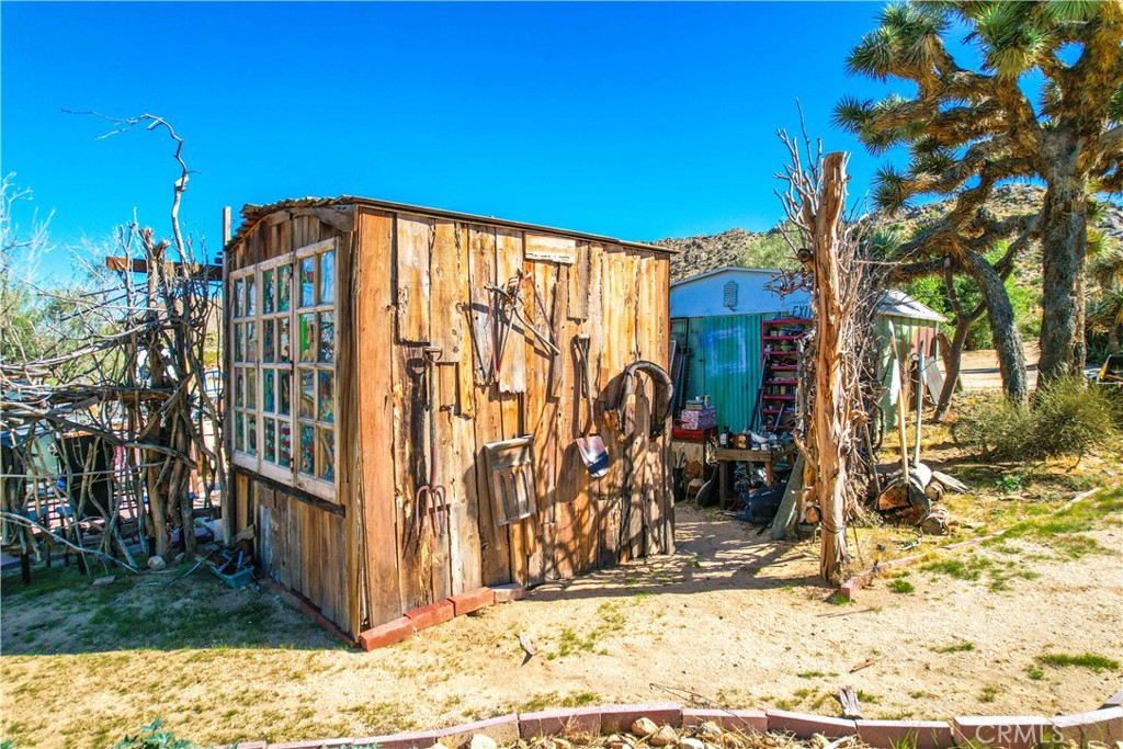59489 Onaga Trail Joshua Tree, CA 92252 - Photo 47 of 73 a view of a house with a yard