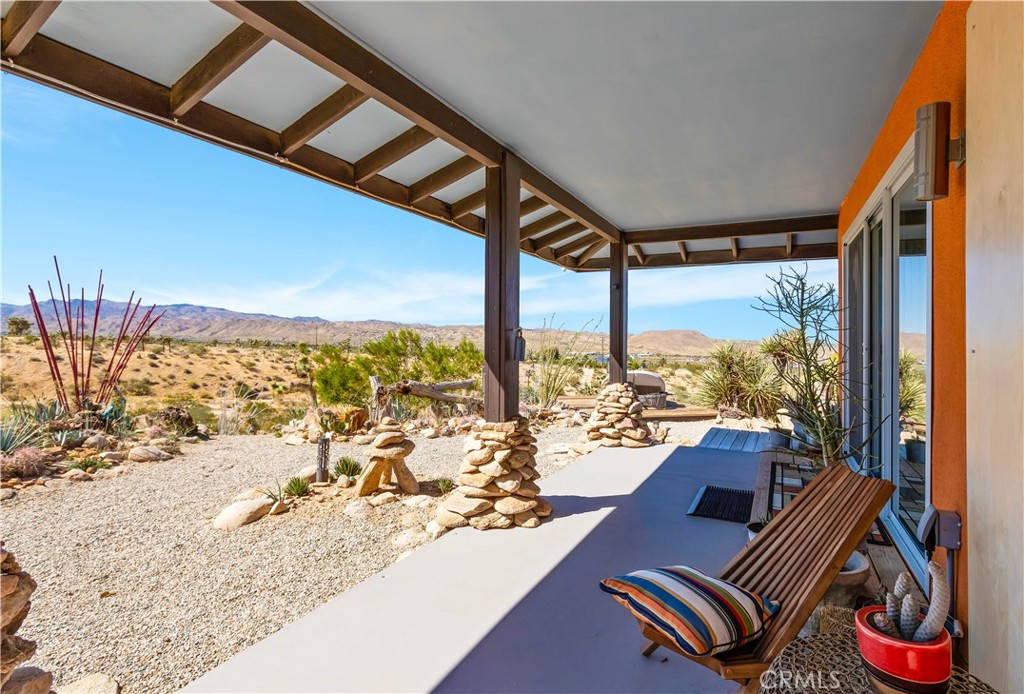 59489 Onaga Trail Joshua Tree, CA 92252 - Photo 6 of 73 a view of a living room and a floor to ceiling window and floor to ceiling window yard