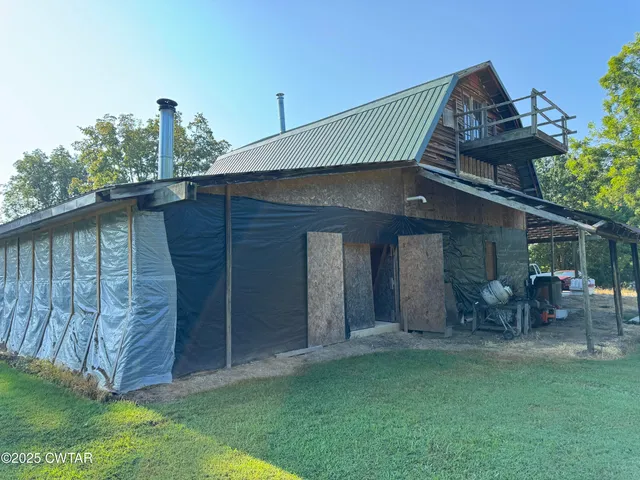 a view of a backyard with table and chairs and potted plants