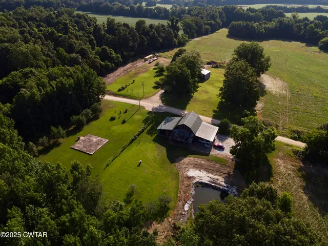 an aerial view of residential house with outdoor space and swimming pool