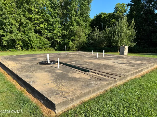 a view of a swimming pool with an outdoor seating and a yard