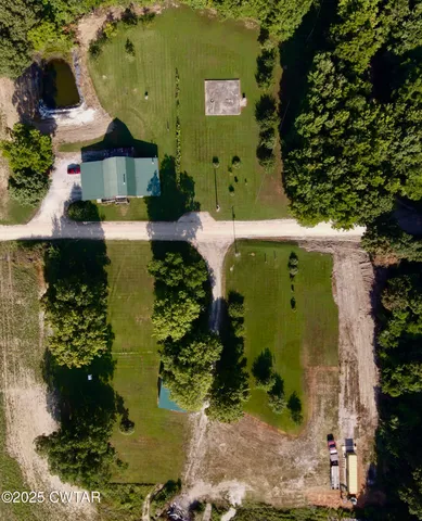 an aerial view of a house with a yard