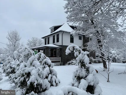 a view of a house with a yard covered with snow in front of house