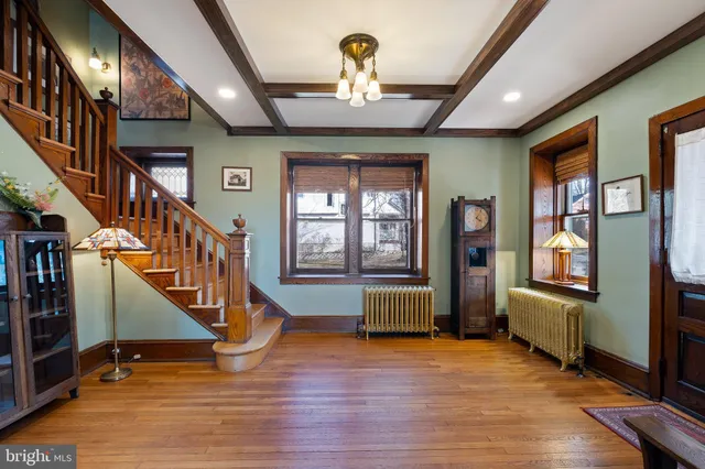 a view of an entryway with wooden floor windows and a livingroom