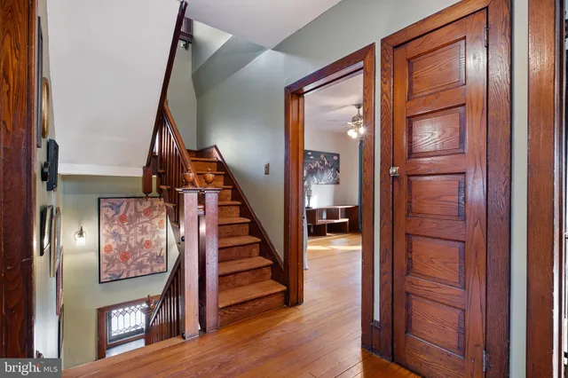 a view of an entryway with wooden floor and staircase