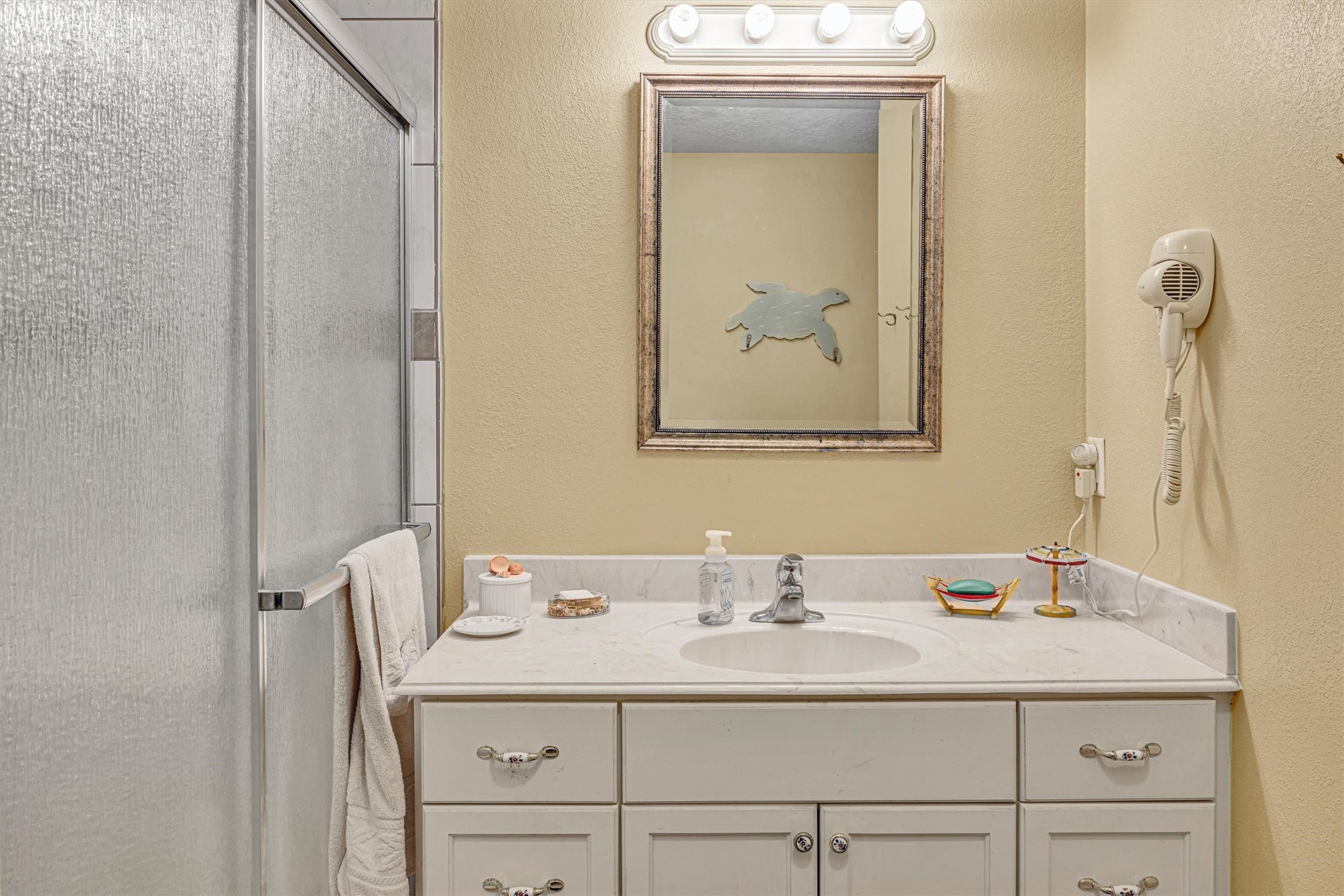 818 Seashell Drive Freeport, TX 77541 - Photo 16 of 23 a bathroom with a sink vanity and a mirror