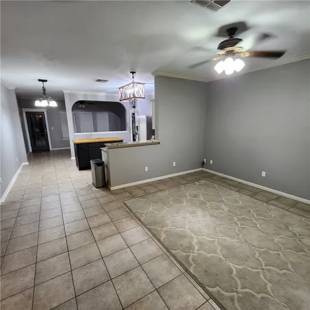 a view of a livingroom with furniture and chandelier fan