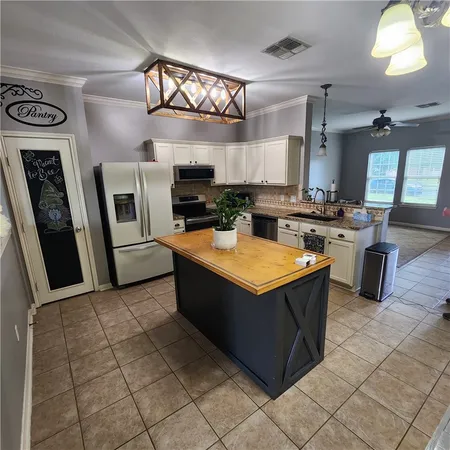 a kitchen with stainless steel appliances granite countertop a sink counter top space cabinets and a window