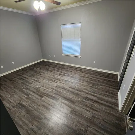 a view of a room with wooden floor