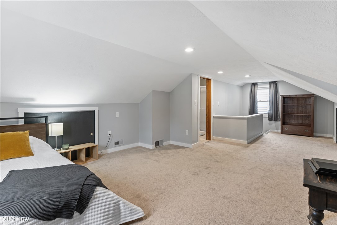 7514 Spring Garden Road Cleveland, OH 44129 - Photo 22 of 30 Upstairs bedroom with light carpeting and a full bathroom