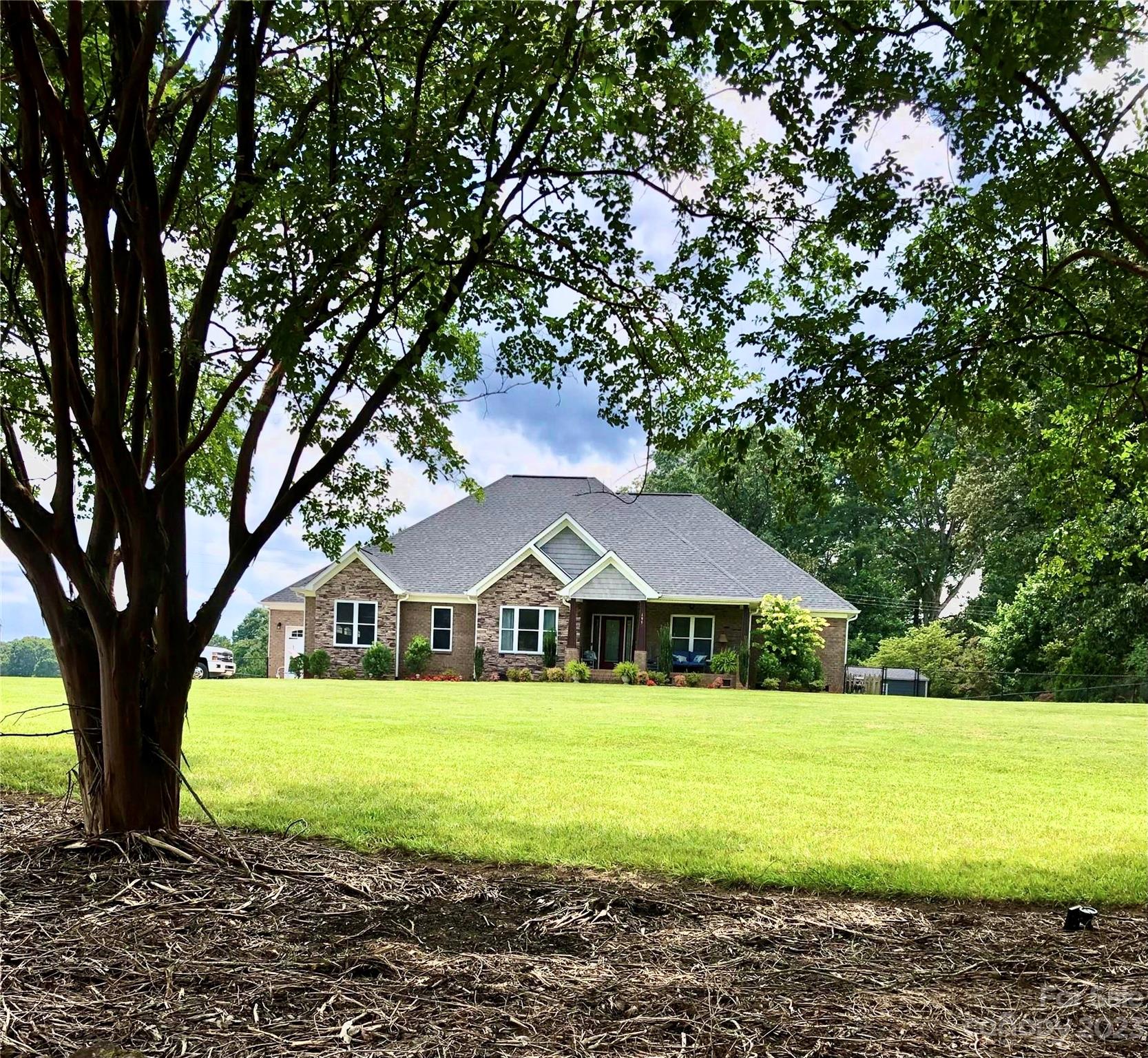 a view of outdoor space with garden and trees