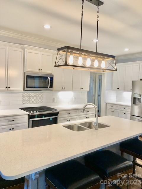 195 Thomas Road Clover, SC 29710 - Photo 12 of 45 a kitchen with kitchen island a stove a sink and a refrigerator with wooden floor