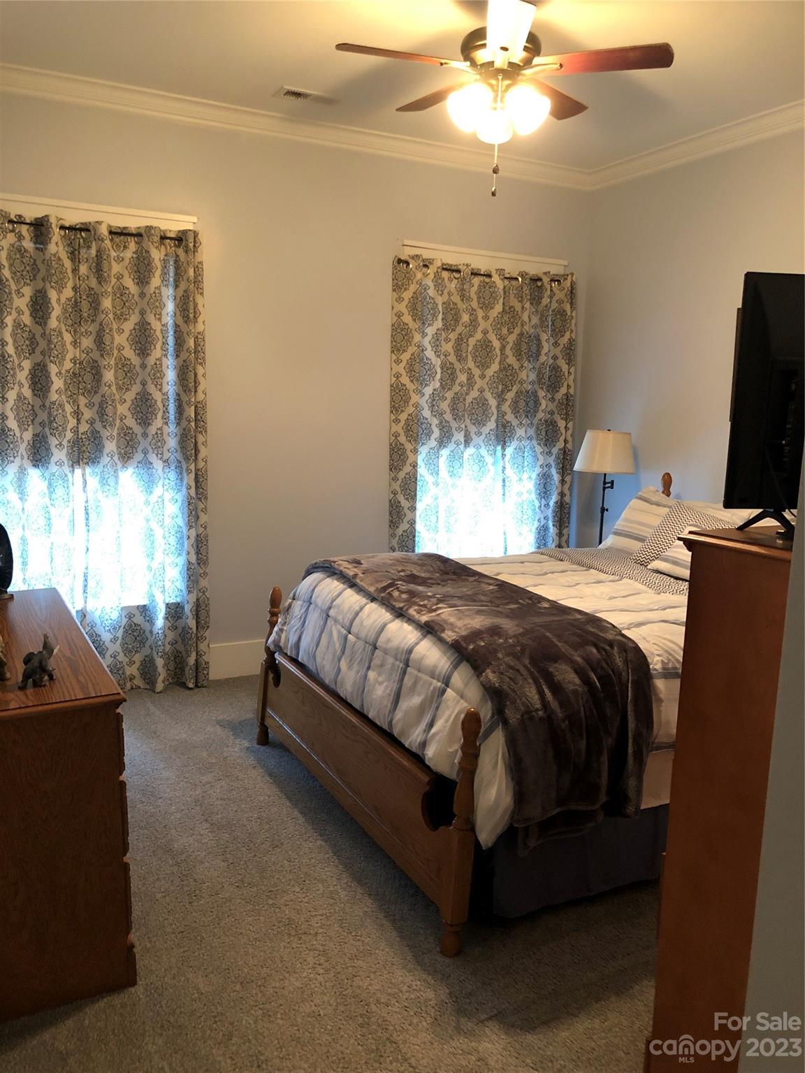 195 Thomas Road Clover, SC 29710 - Photo 21 of 45 a bedroom with a bed and a chandelier