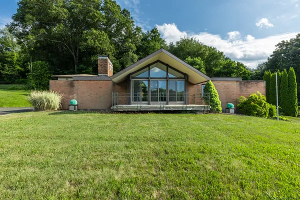 a front view of a house with garden