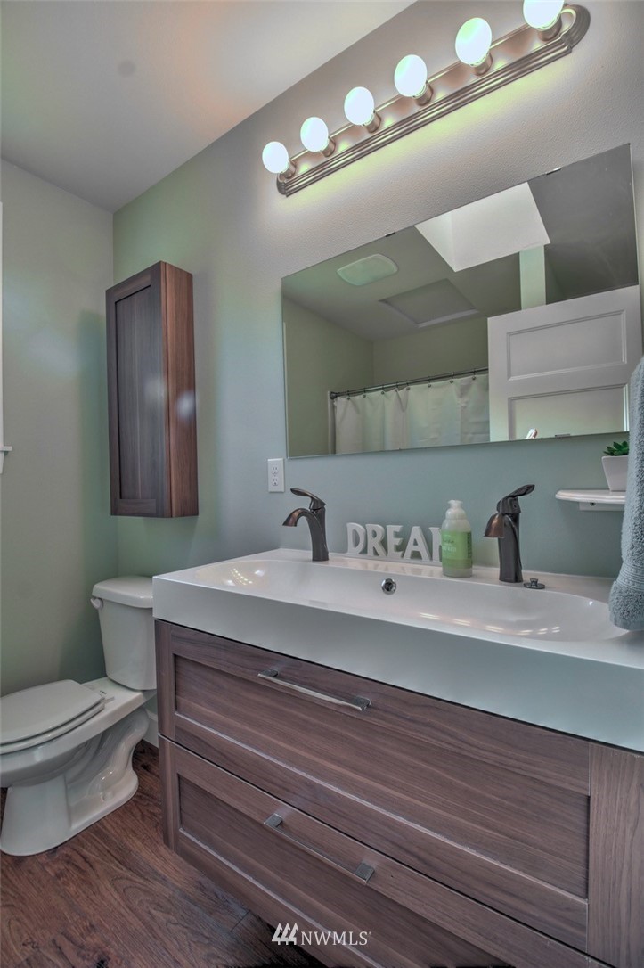 6131 Maytown Road Southwest Olympia, WA 98512 - Photo 16 of 39 a bathroom with a toilet a sink and mirror