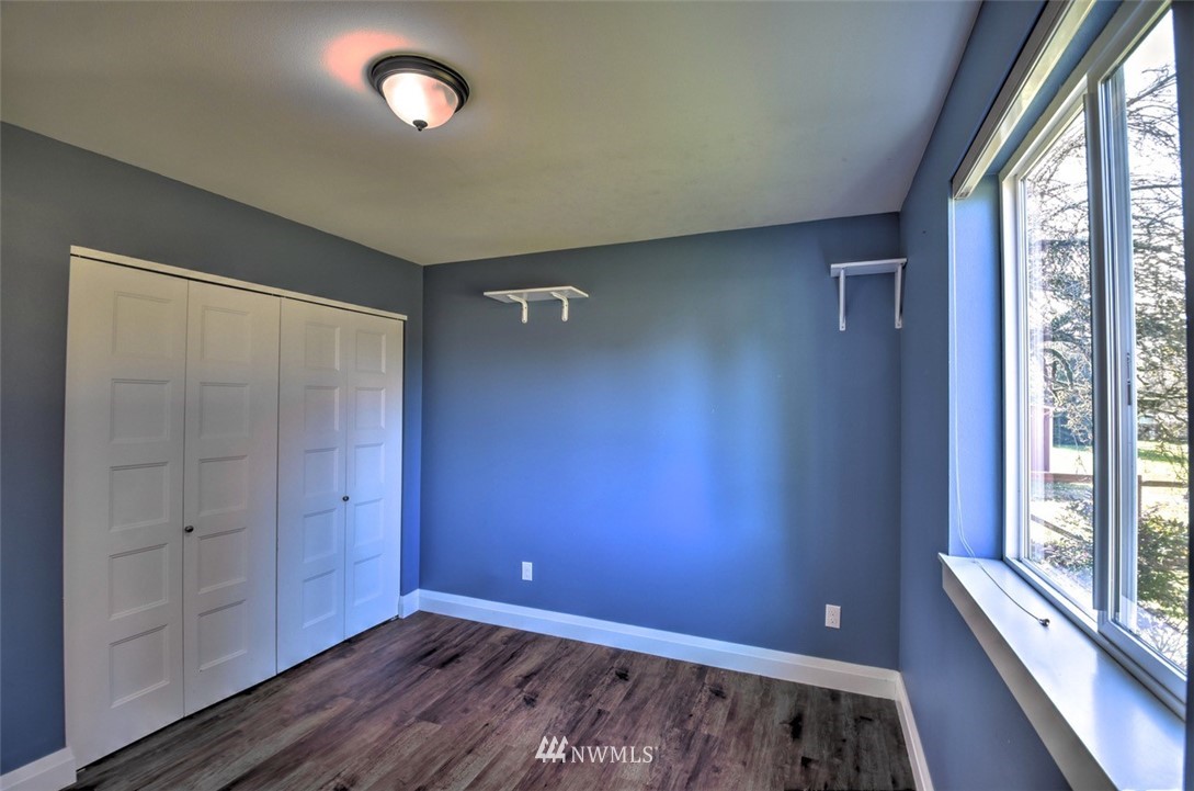 6131 Maytown Road Southwest Olympia, WA 98512 - Photo 20 of 39 an empty room with wooden floor and windows