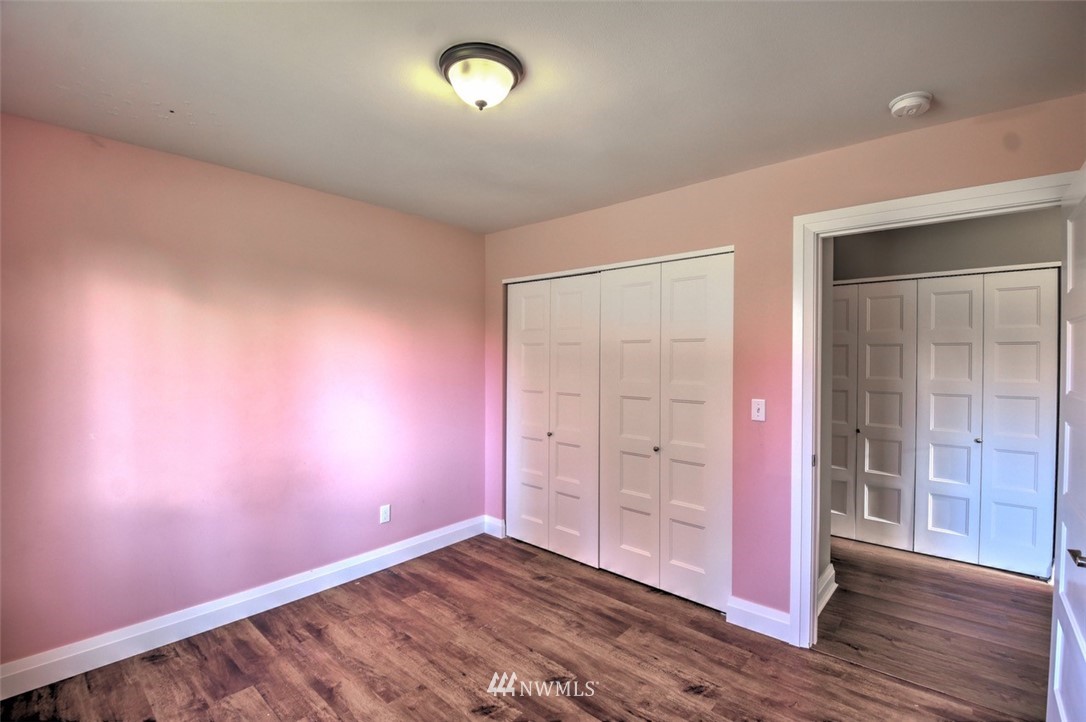 6131 Maytown Road Southwest Olympia, WA 98512 - Photo 21 of 39 an empty room with wooden floor and windows