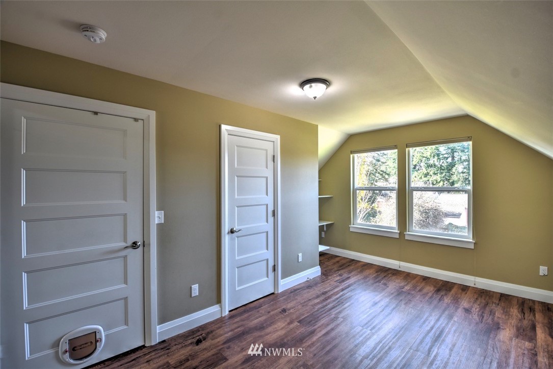 6131 Maytown Road Southwest Olympia, WA 98512 - Photo 22 of 39 a view of an empty room with a window and wooden floor