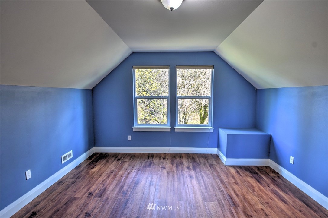 6131 Maytown Road Southwest Olympia, WA 98512 - Photo 25 of 39 an empty room with wooden floor and windows