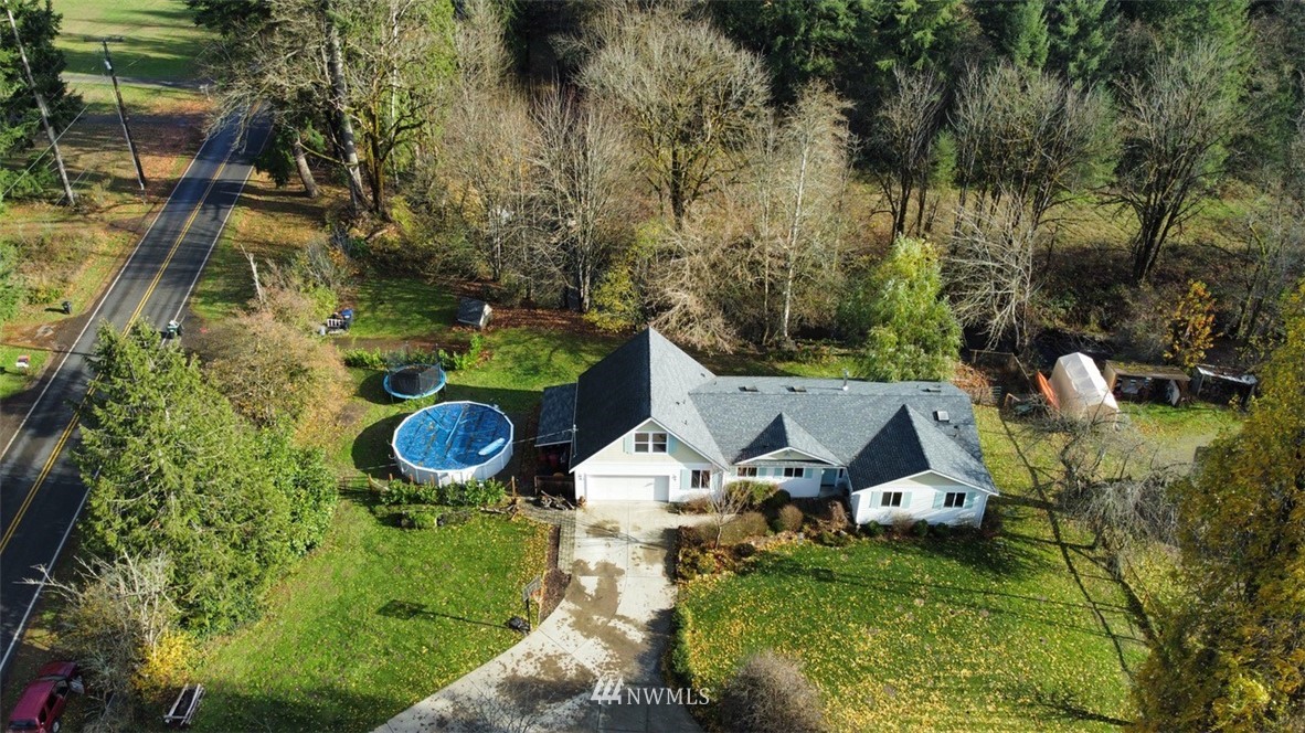 6131 Maytown Road Southwest Olympia, WA 98512 - Photo 33 of 39 an aerial view of a house with garden space and trees