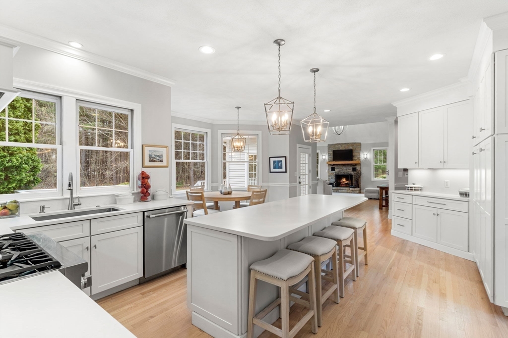11 Barnside Road Boxford, MA 01921 - Photo 15 of 42 a large kitchen with kitchen island a sink a stove a dining table and chairs