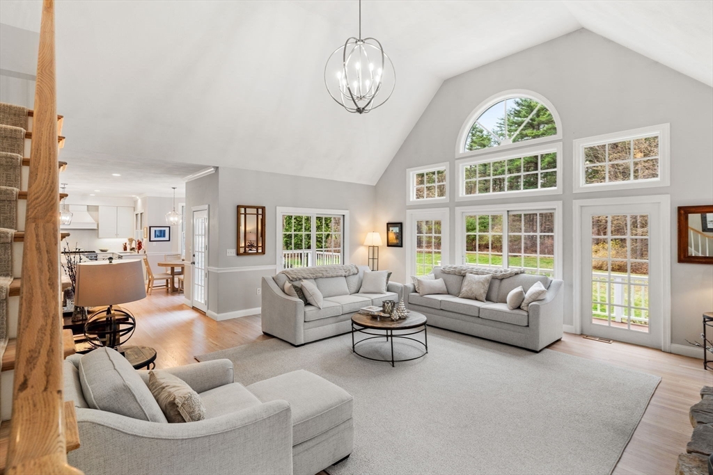 11 Barnside Road Boxford, MA 01921 - Photo 18 of 42 a living room with furniture chandelier and a large window