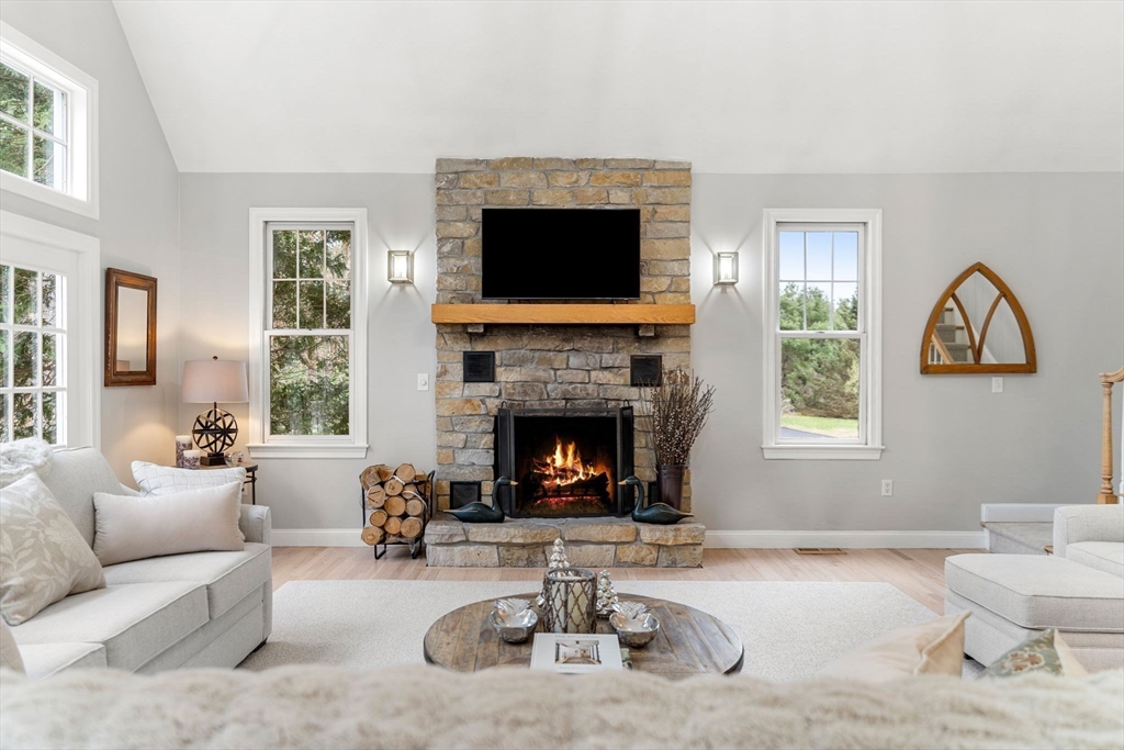 11 Barnside Road Boxford, MA 01921 - Photo 22 of 42 a living room with furniture a flat screen tv and a fireplace