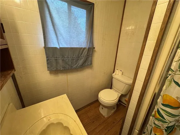 a bathroom with a sink and a granite countertop toilet