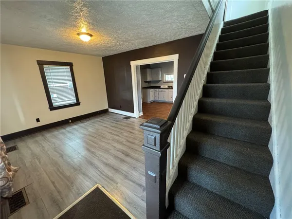 a view of an entryway with wooden floor