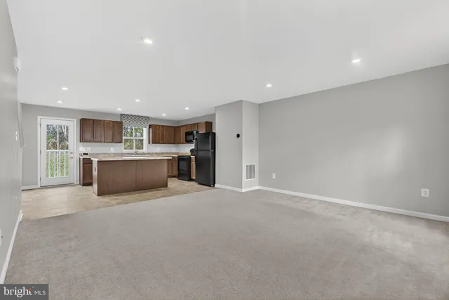 a kitchen with stainless steel appliances granite countertop a sink counter space cabinets and a large window